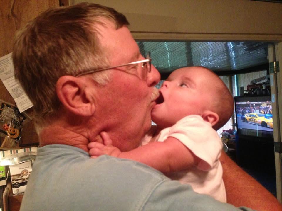A man kissing a baby