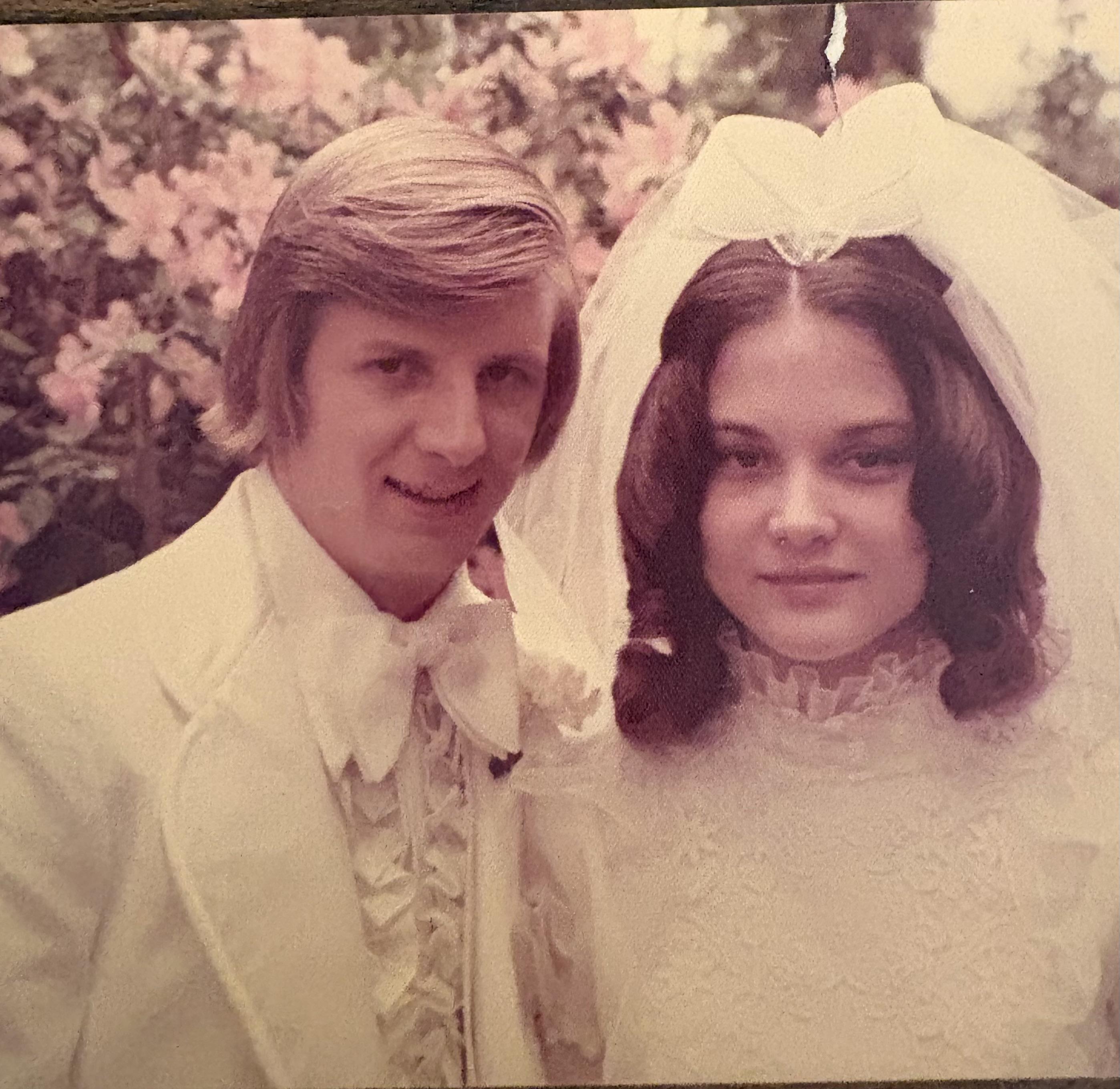 A man and woman in wedding attire
