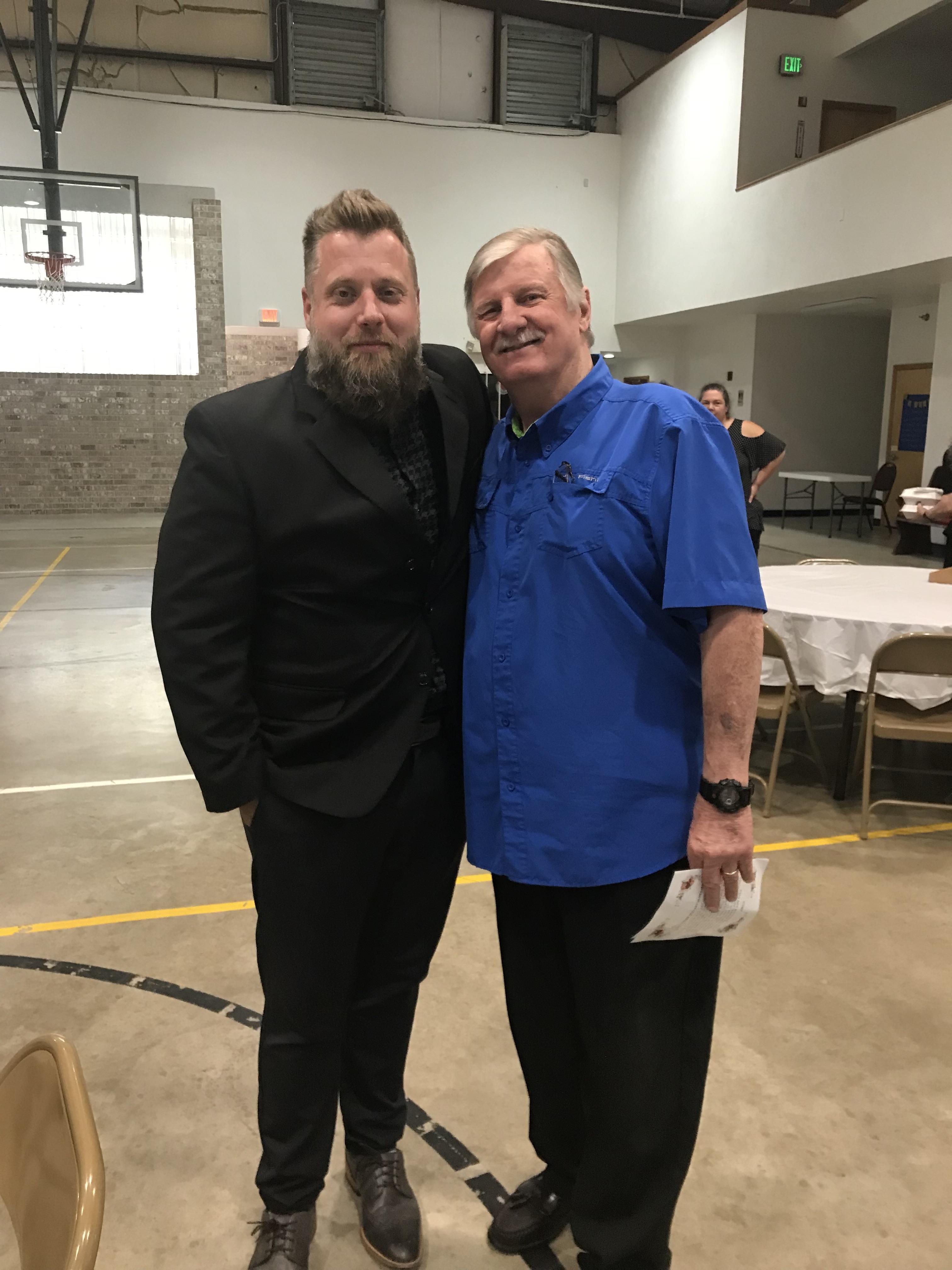 Two men standing together in a room