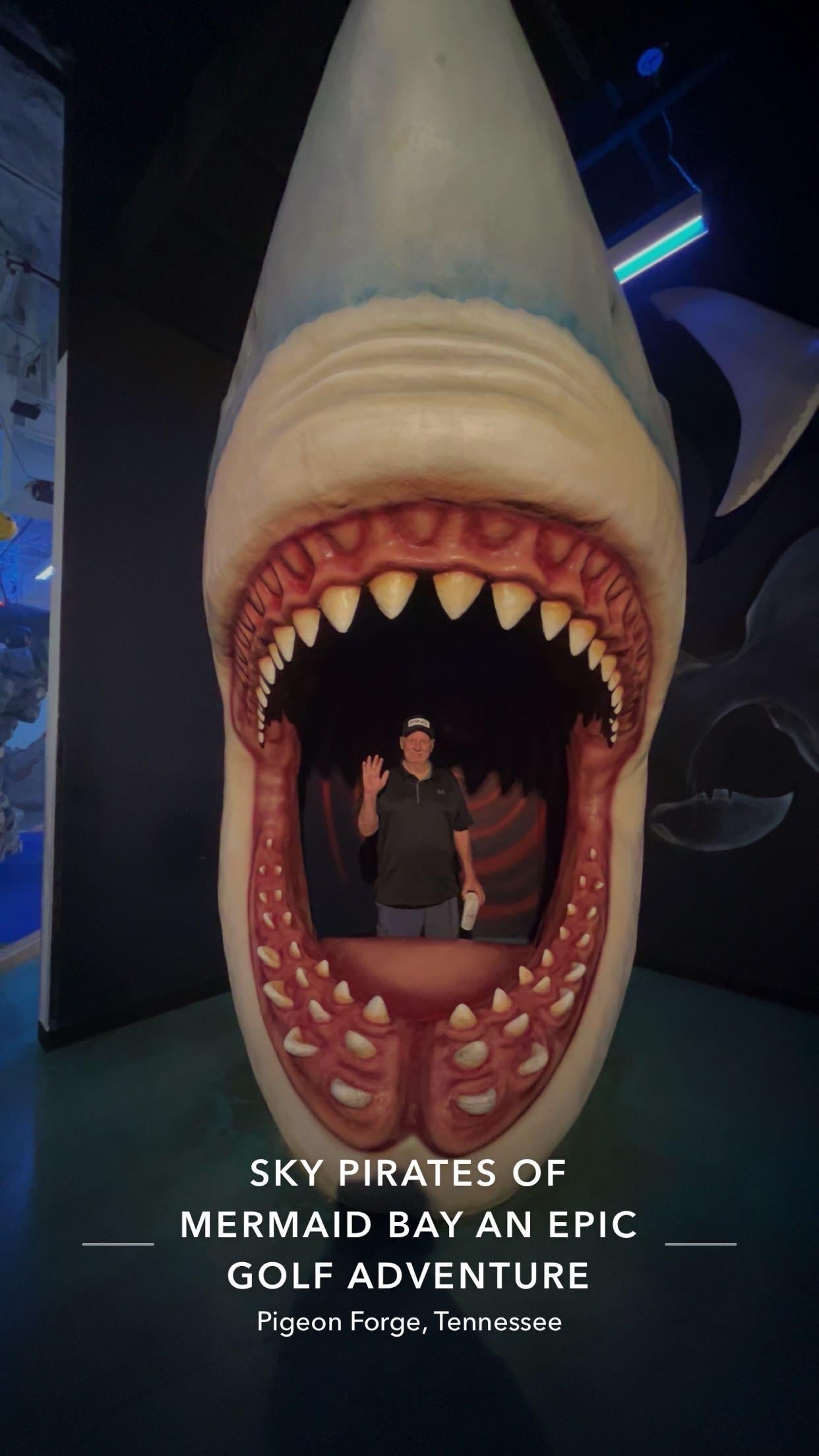 A man standing in a shark mouth