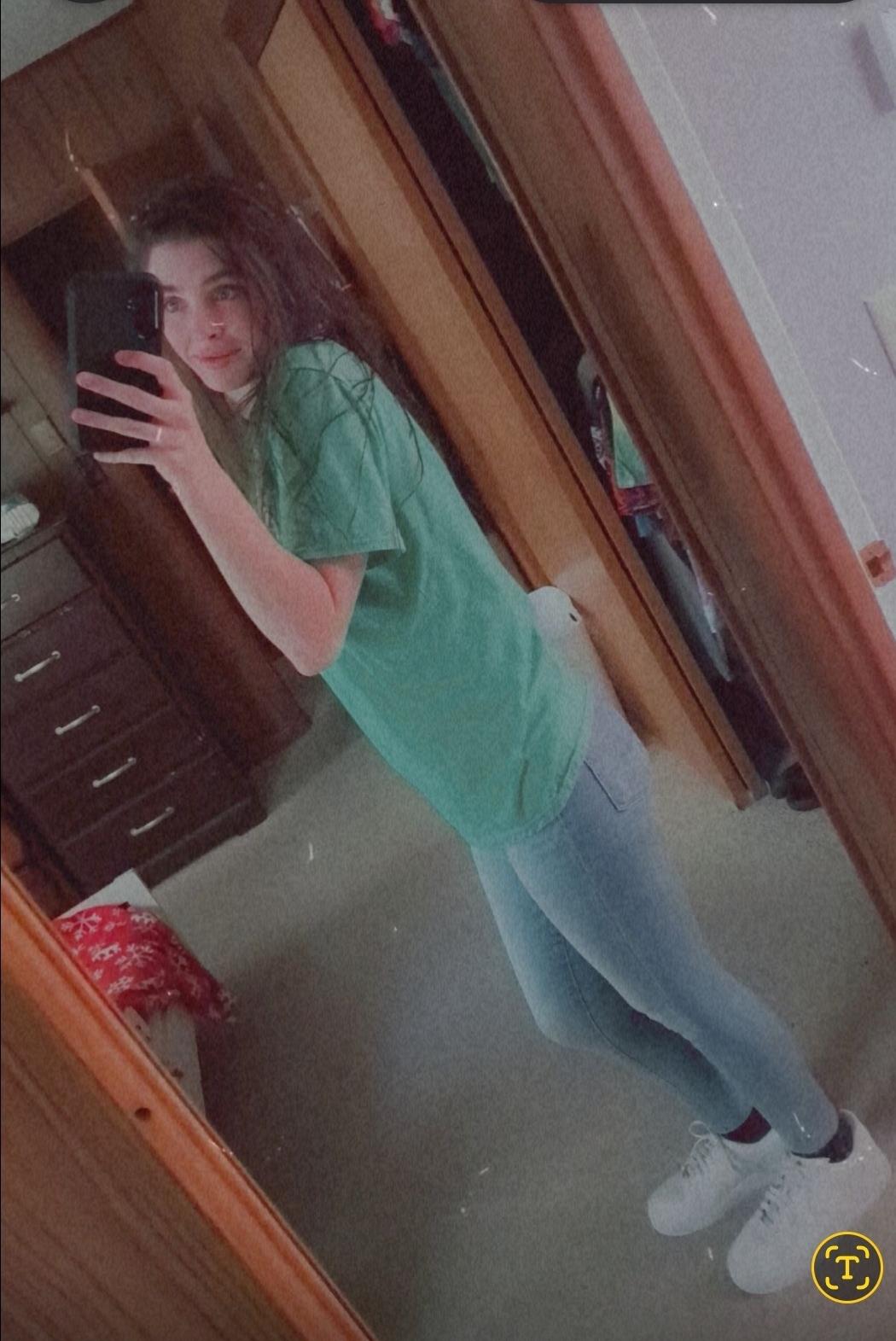 A woman taking a selfie in a mirror