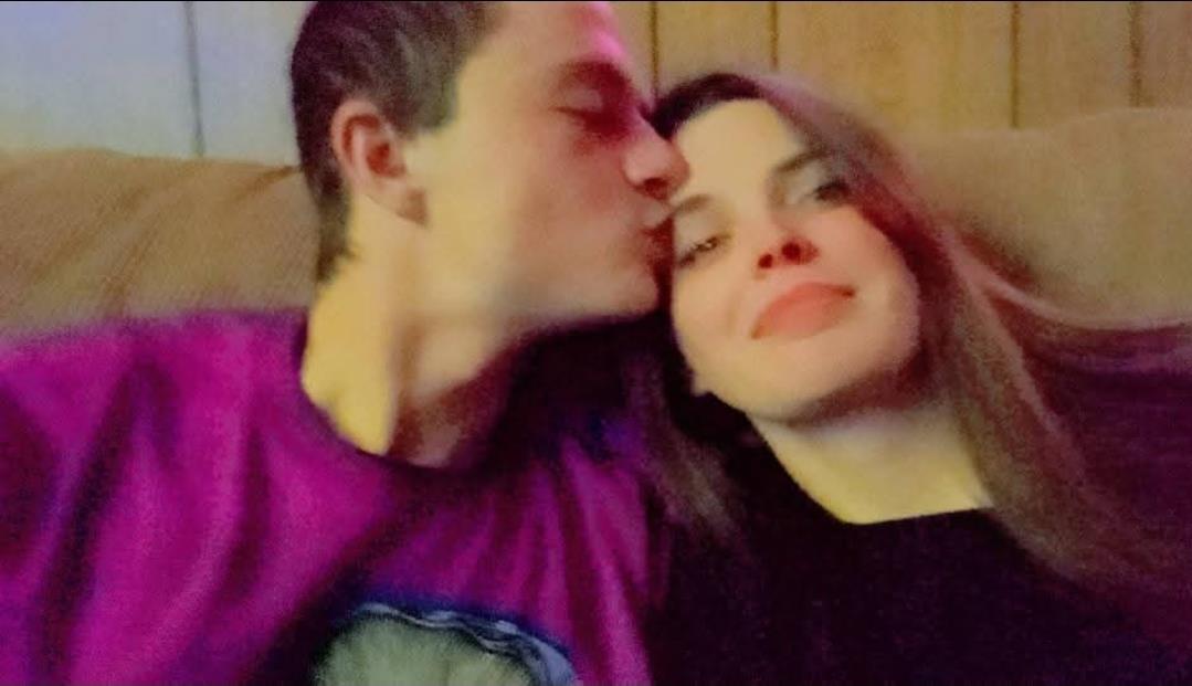 A man kissing a woman's cheek
