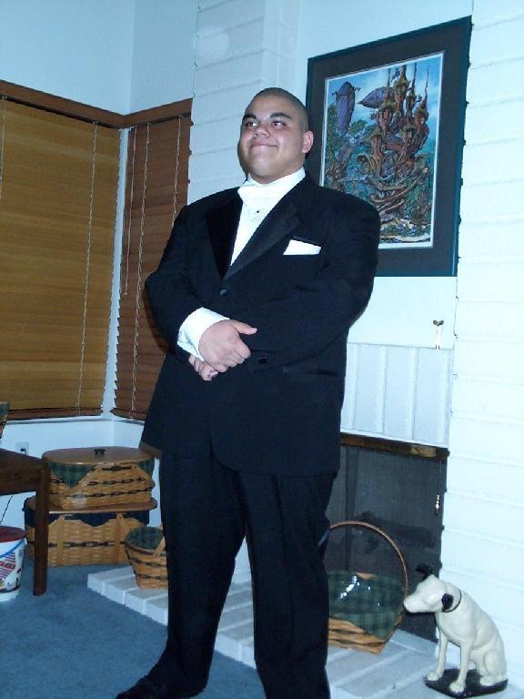 A man in a tuxedo and a dog
