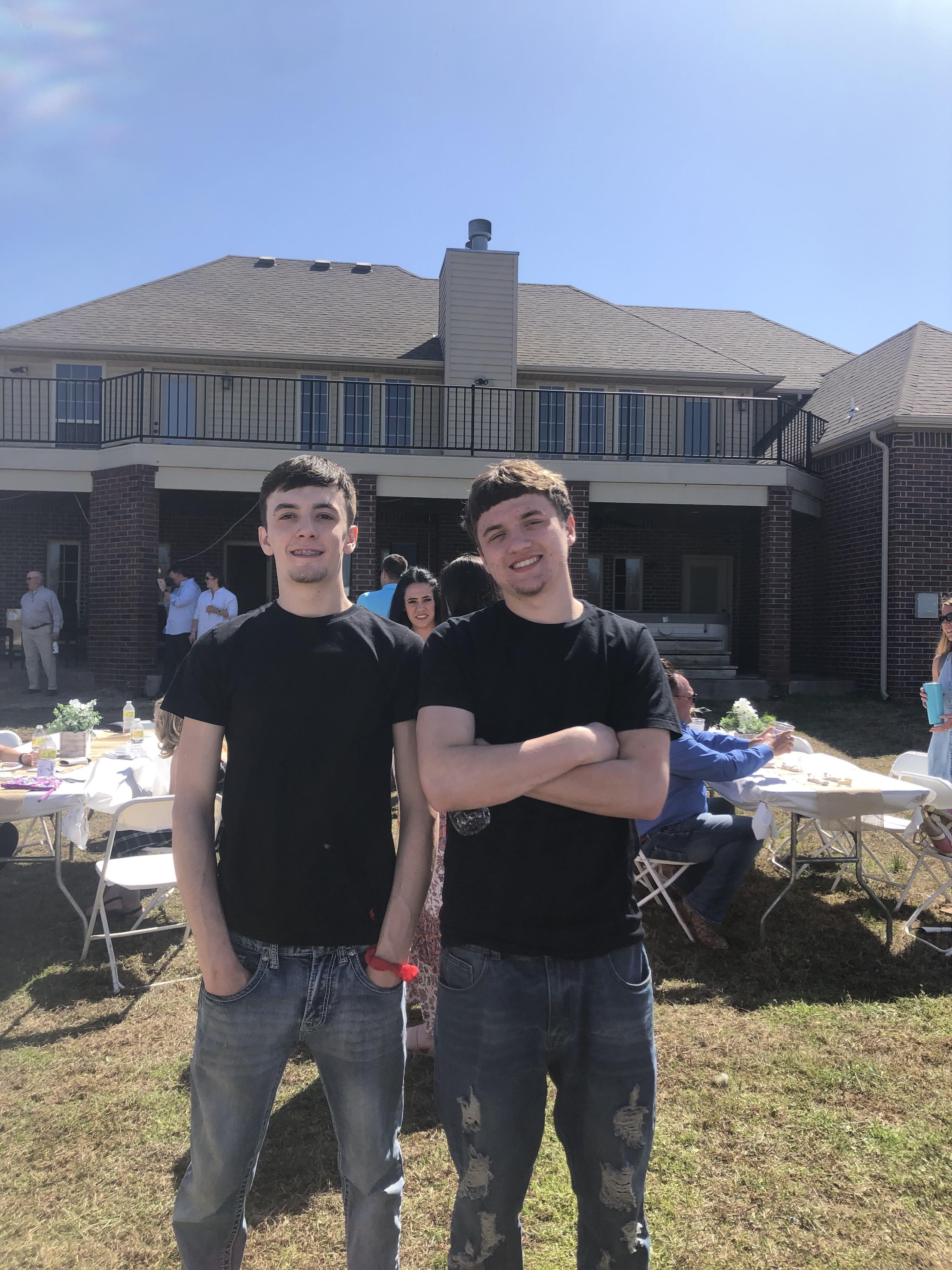 Two men standing in front of a house