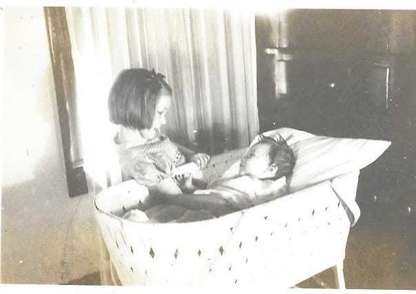 A girl holding a baby
