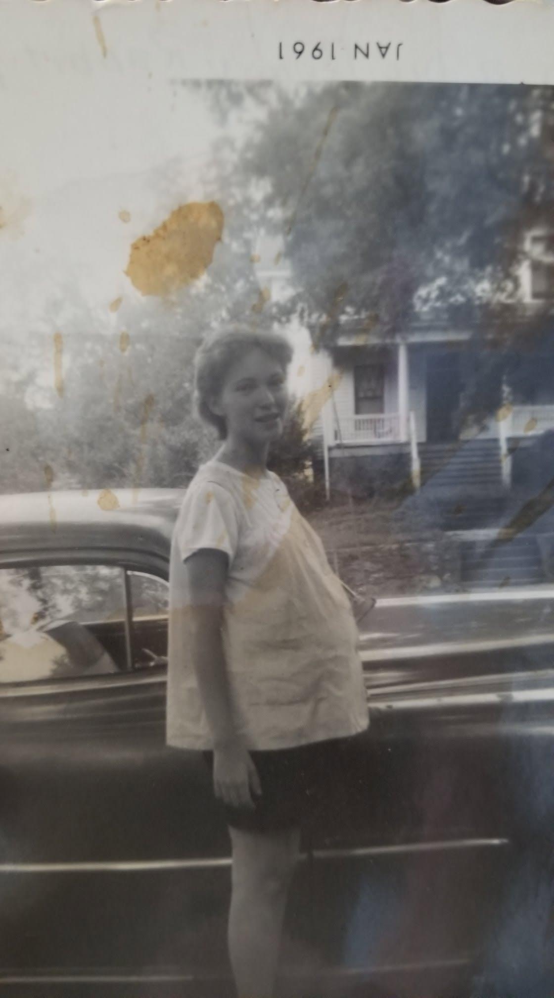 A woman standing next to a car