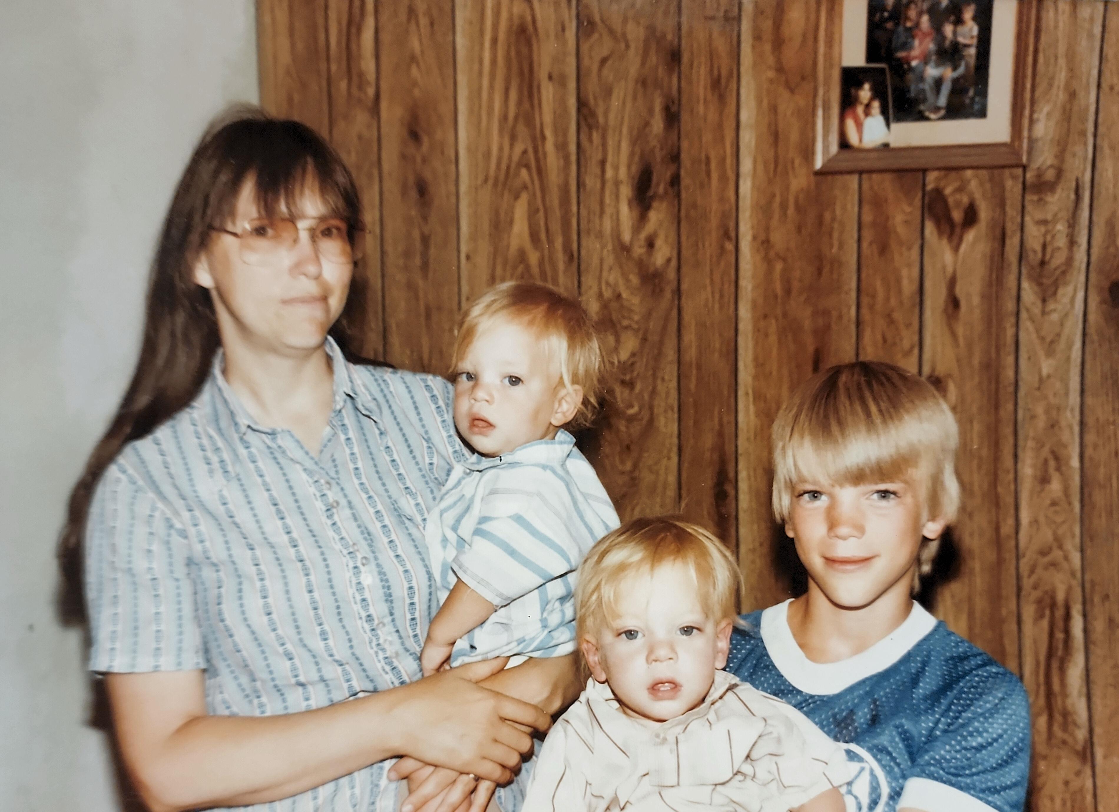 A woman holding a group of children