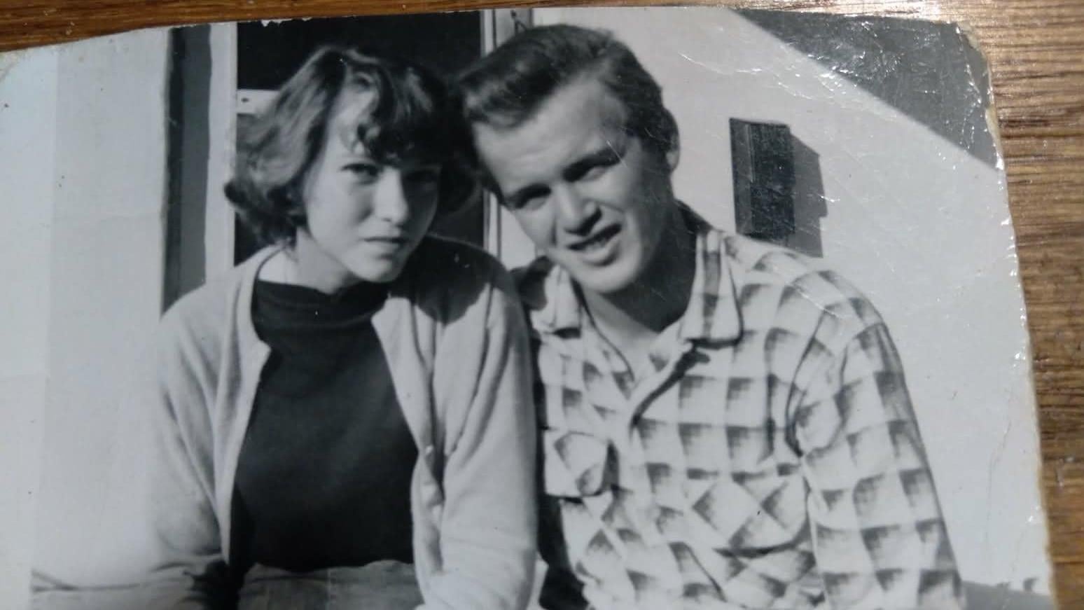 A man and woman posing for a picture