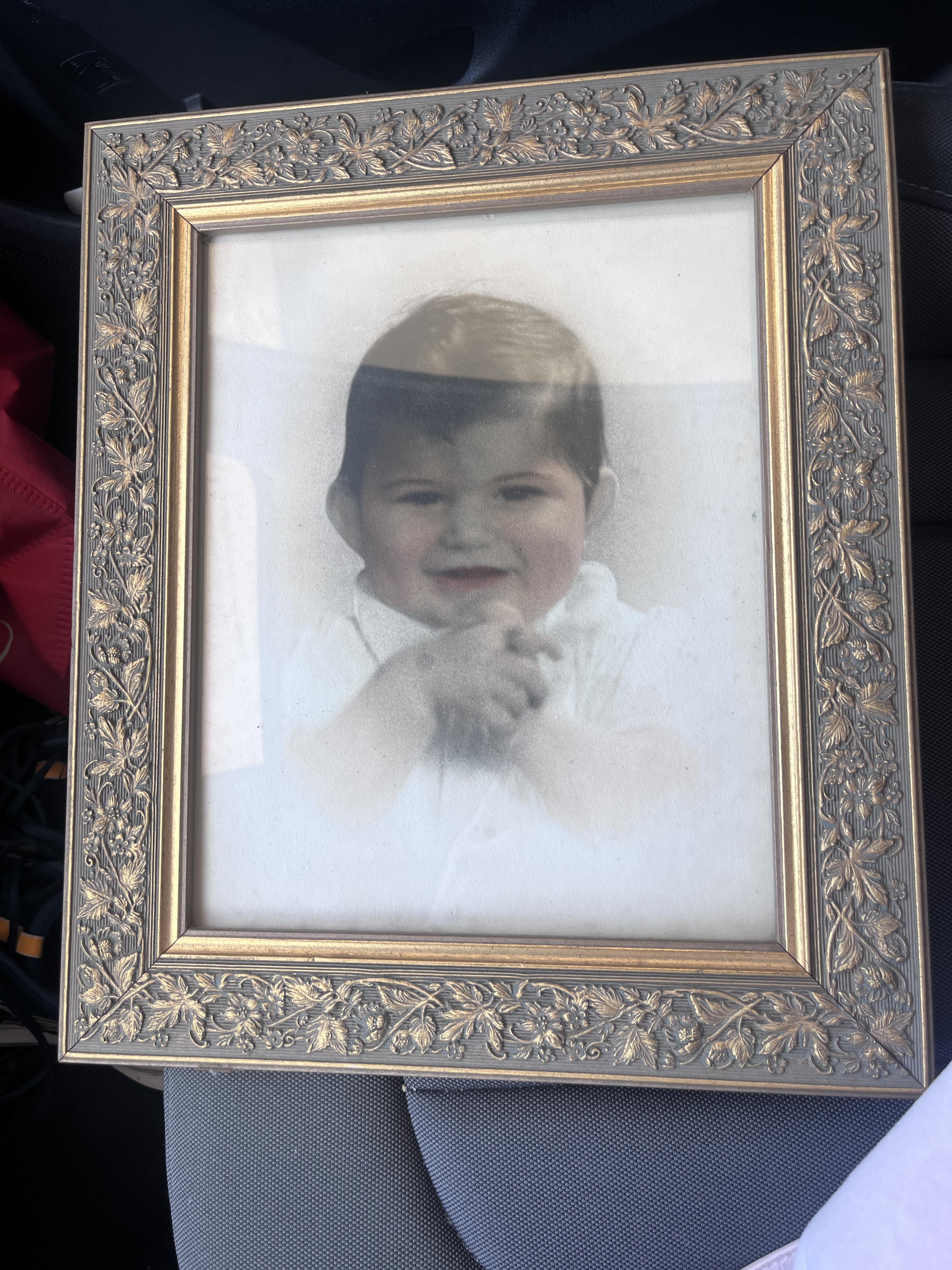 A framed picture of a baby