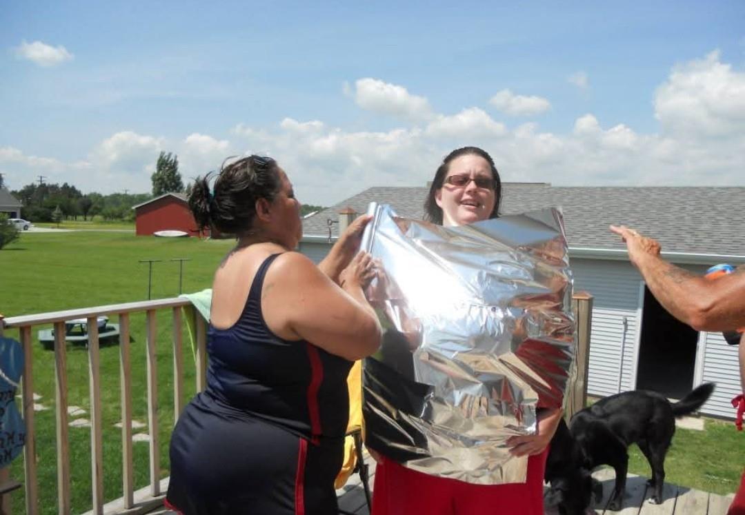 A couple of women holding a foil