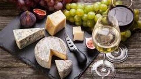 A cheese and grapes on a table