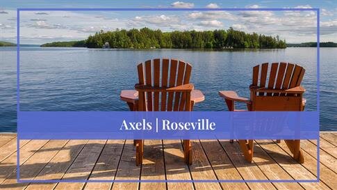 Two chairs on a dock overlooking a lake