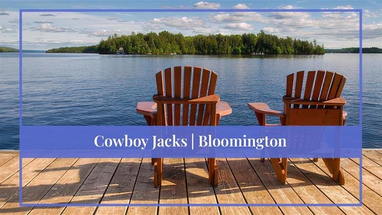 A couple of wooden chairs on a dock overlooking a lake